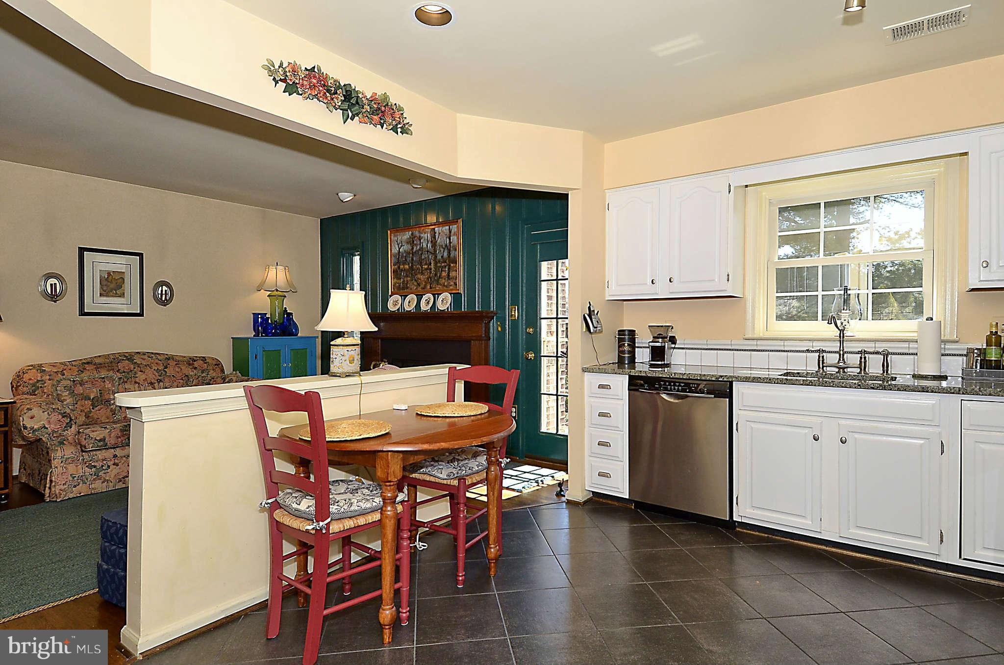 10708 Brewer House Road North Bethesda, MD 20852 - Photo 8 of 26 a kitchen with a refrigerator a stove a sink dishwasher with a dining table and chairs
