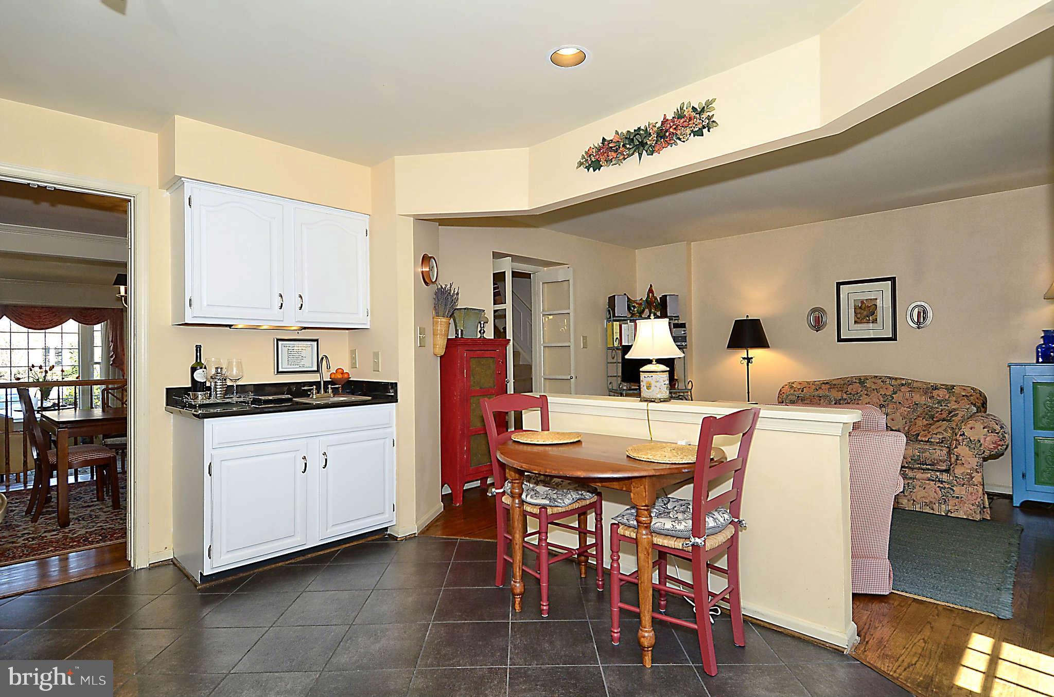 10708 Brewer House Road North Bethesda, MD 20852 - Photo 9 of 26 a kitchen with stainless steel appliances kitchen island granite countertop a table chairs and a refrigerator
