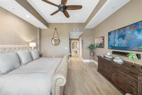a bedroom with a bed and a ceiling fan