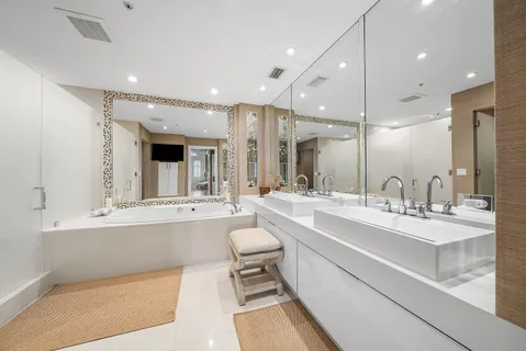 a bedroom with a bed and a flat tv screen on a dresser