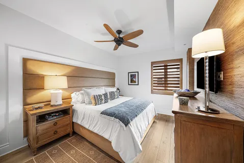 a bedroom with a bed and flat screen tv