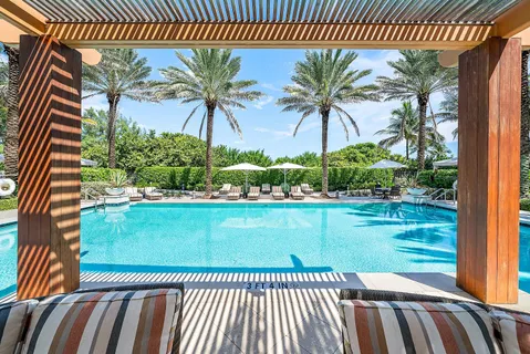 a kitchen with stainless steel appliances granite countertop a sink a stove and chairs