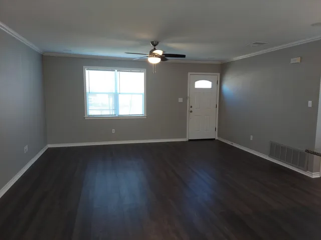 a view of wooden floor and windows in a room