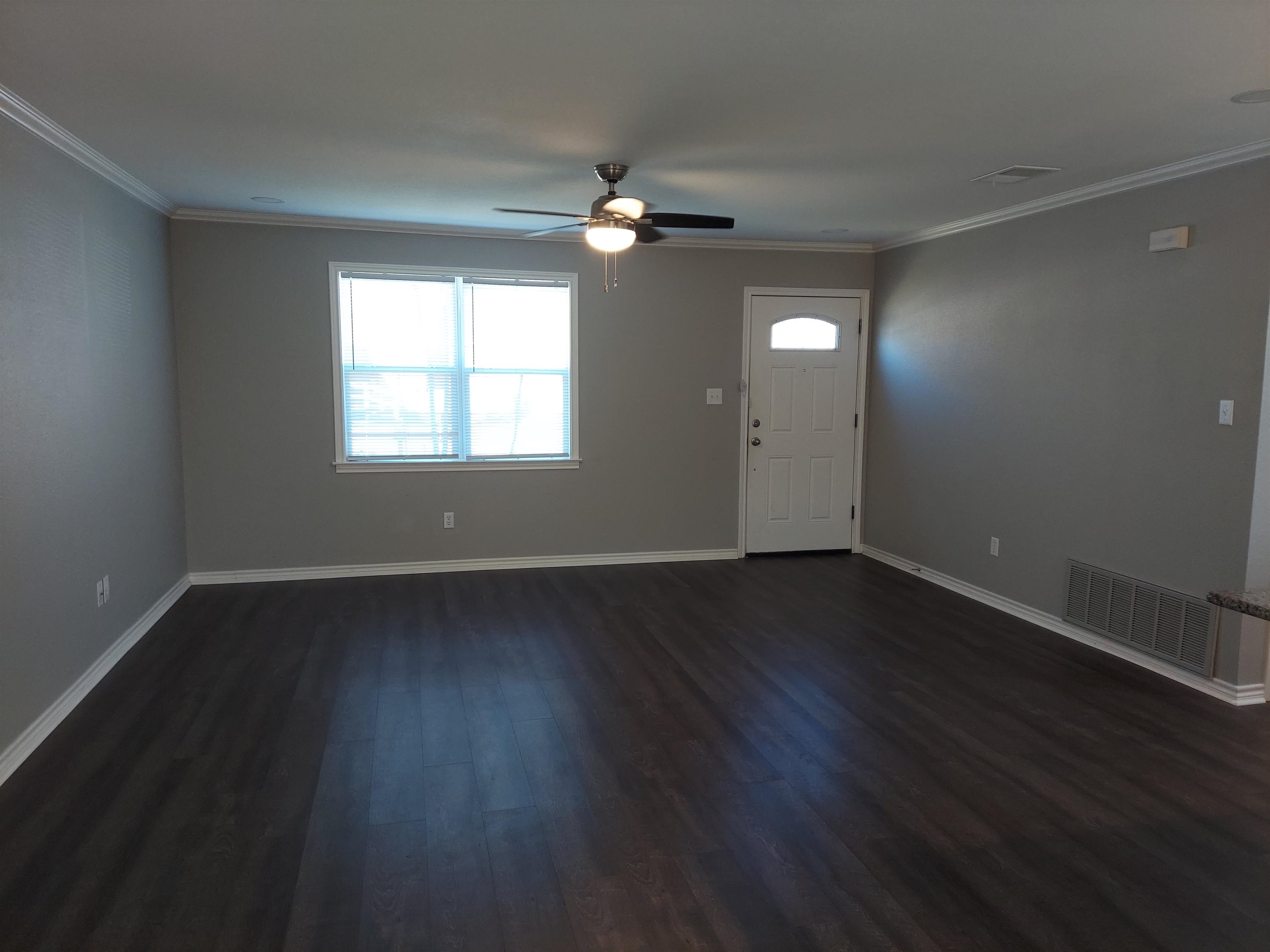 606 South Pierce Street Burnet, TX 78611 - Photo 2 of 9 a view of wooden floor and windows in a room
