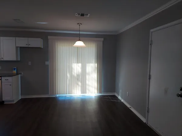 a view of wooden floor and windows in a kitchen