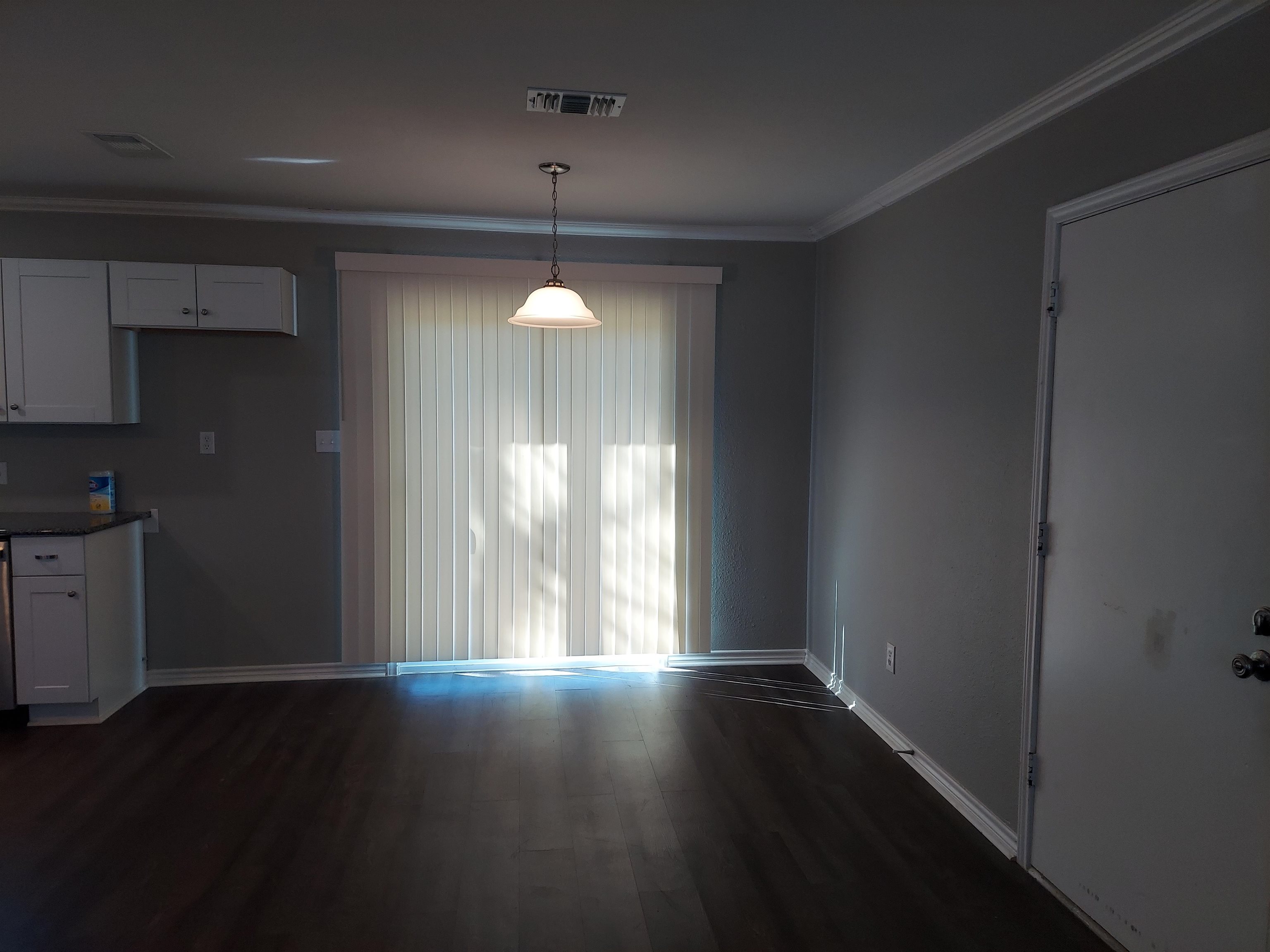 606 South Pierce Street Burnet, TX 78611 - Photo 5 of 9 a view of wooden floor and windows in a kitchen