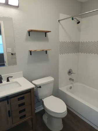 a bathroom with a sink toilet and shower