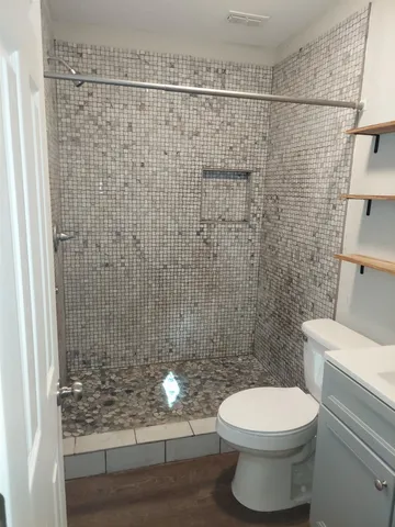 a bathroom with a toilet and shower