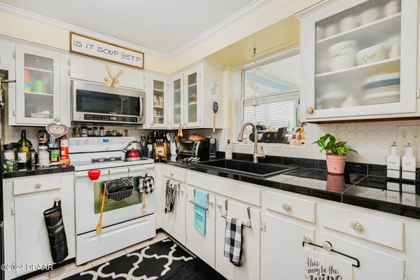 a kitchen with stainless steel appliances kitchen island granite countertop a refrigerator and a sink