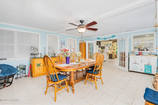 a dining room with furniture and a chandelier