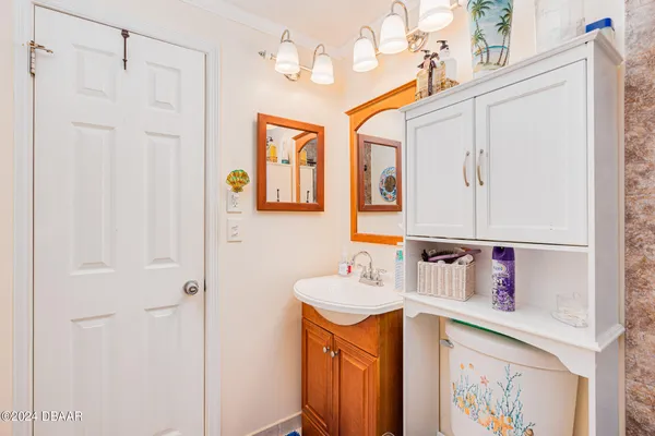 a bathroom with a sink a toilet a mirror and shower