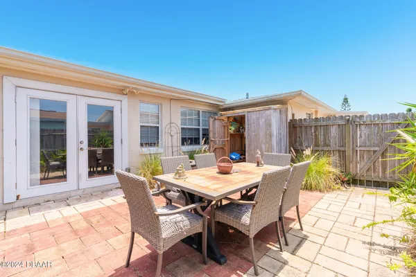 a view of a patio with a table and chairs