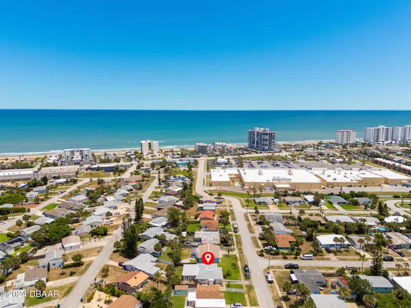 an aerial view of residential building and ocean
