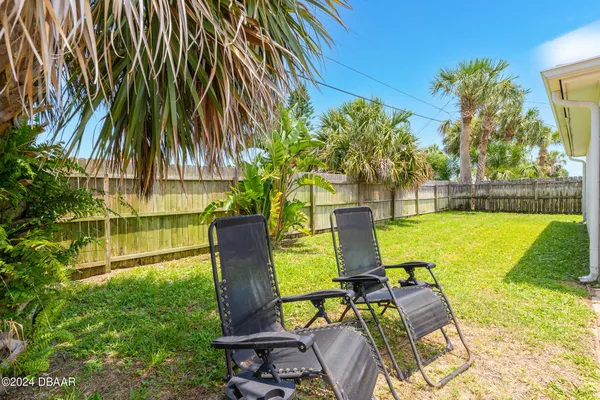 a swimming pool with outdoor seating and yard