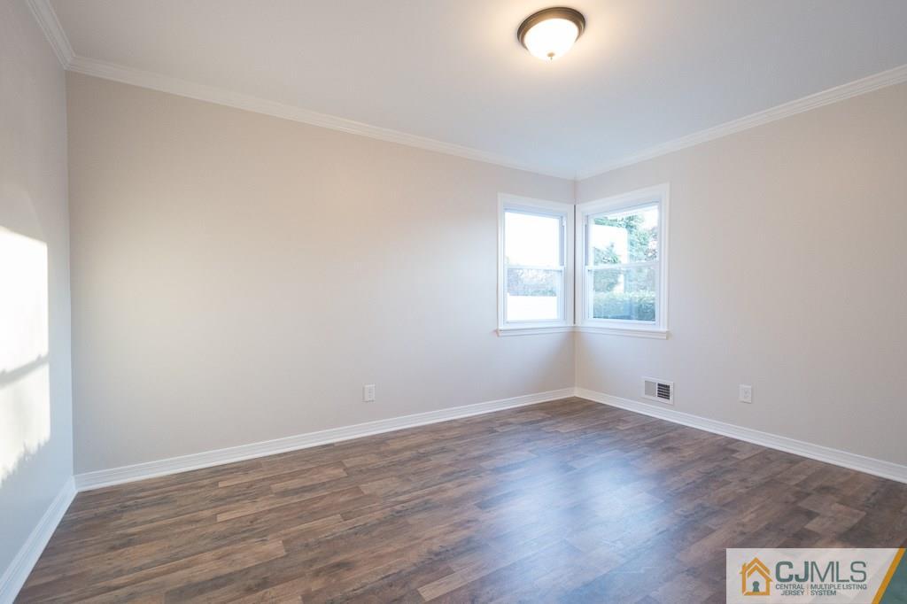5 High Point Road East Brunswick, NJ 08816 - Photo 11 of 24 an empty room with wooden floor and windows