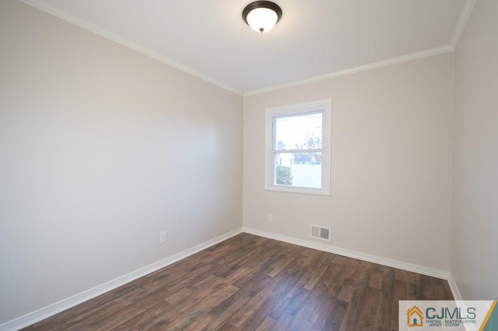 5 High Point Road East Brunswick, NJ 08816 - Photo 12 of 24 an empty room with wooden floor and windows