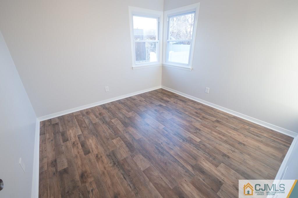 5 High Point Road East Brunswick, NJ 08816 - Photo 13 of 24 an empty room with wooden floor and windows