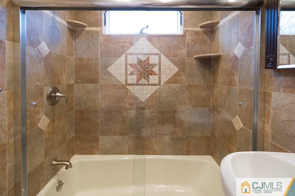 5 High Point Road East Brunswick, NJ 08816 - Photo 14 of 24 a bathroom with a bathtub and shower