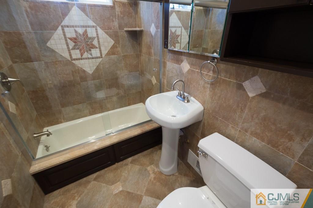 5 High Point Road East Brunswick, NJ 08816 - Photo 15 of 24 a bathroom with a sink a mirror and a toilet