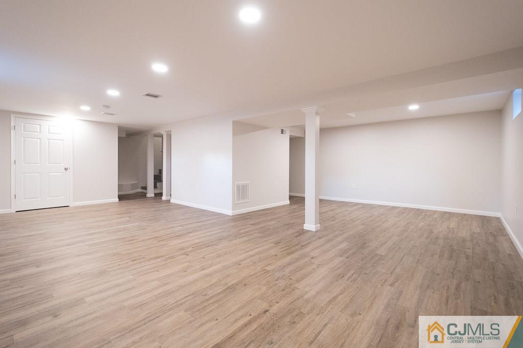 5 High Point Road East Brunswick, NJ 08816 - Photo 16 of 24 a view of an empty room with wooden floor