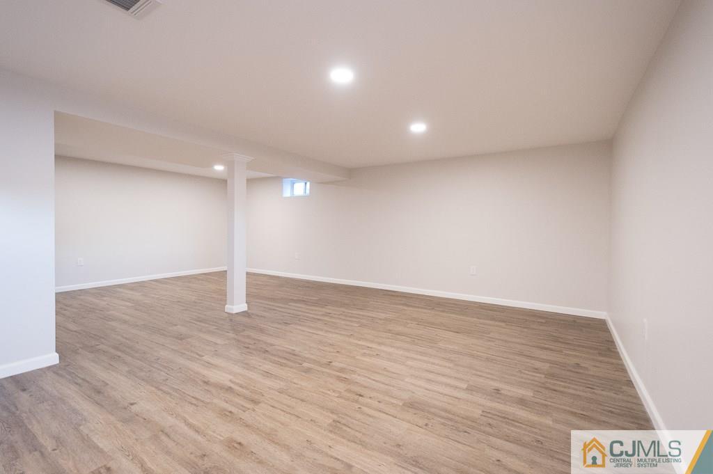 5 High Point Road East Brunswick, NJ 08816 - Photo 18 of 24 a view of an empty room with wooden floor