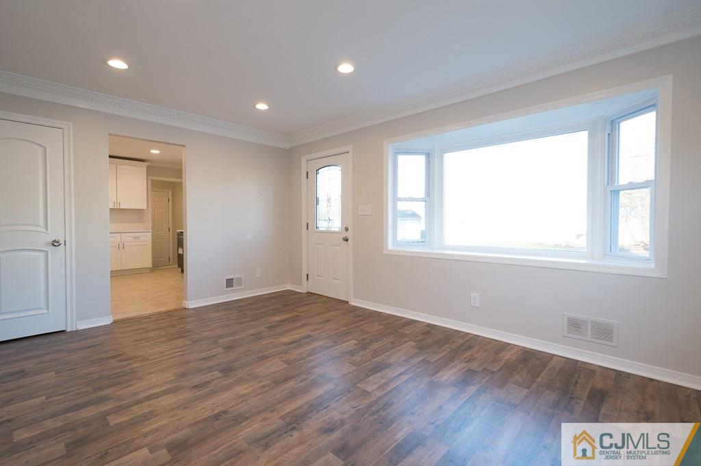 5 High Point Road East Brunswick, NJ 08816 - Photo 3 of 24 a view of an empty room with wooden floor and a window