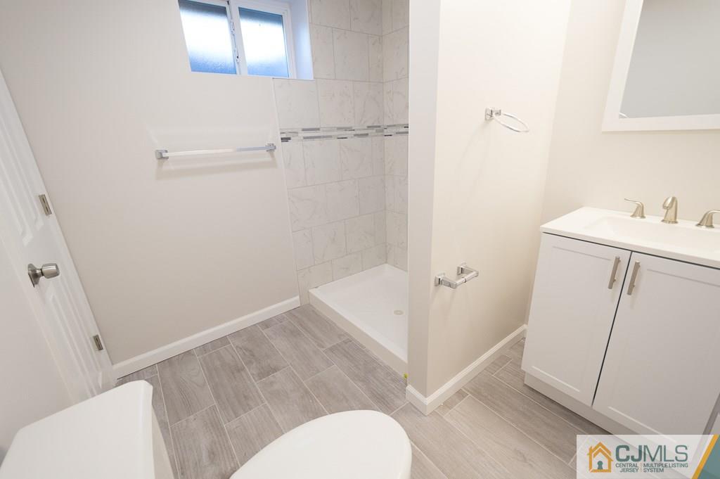 5 High Point Road East Brunswick, NJ 08816 - Photo 21 of 24 a bathroom with a sink toilet and shower