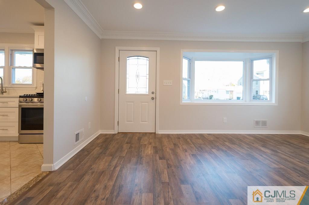 5 High Point Road East Brunswick, NJ 08816 - Photo 4 of 24 an empty room with wooden floor and windows