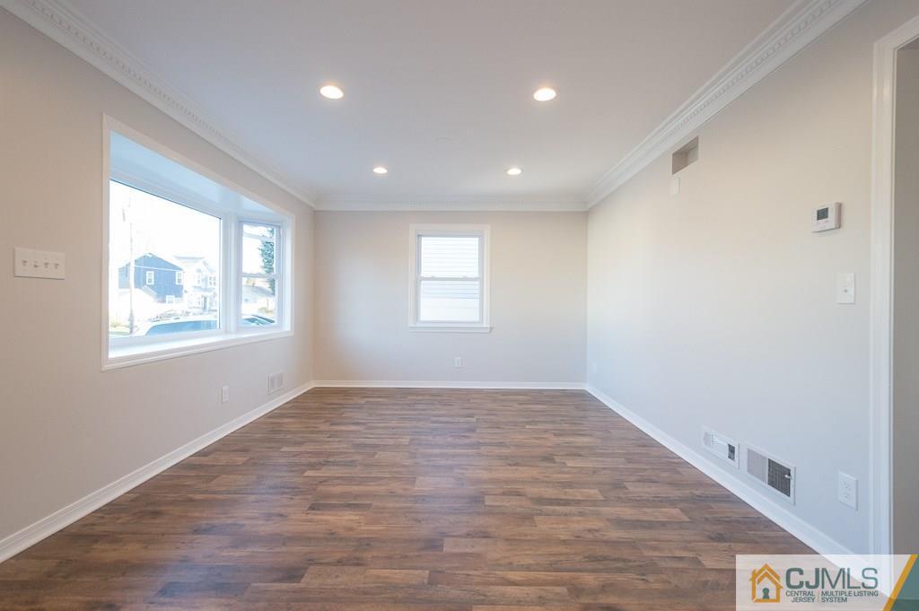 5 High Point Road East Brunswick, NJ 08816 - Photo 5 of 24 a view of empty room with wooden floor and fan