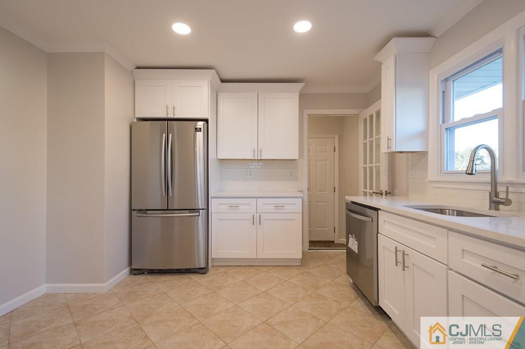 5 High Point Road East Brunswick, NJ 08816 - Photo 7 of 24 a kitchen with a refrigerator sink and cabinets
