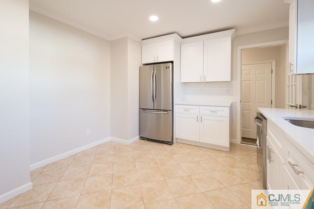 5 High Point Road East Brunswick, NJ 08816 - Photo 10 of 24 a kitchen with granite countertop a refrigerator sink stove and cabinets