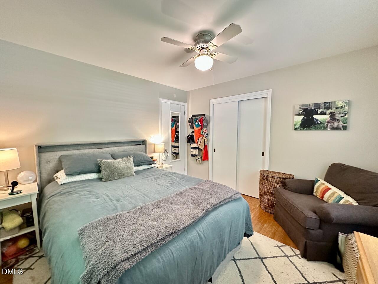 2813 Barmettler Street Raleigh, NC 27607 - Photo 12 of 22 a bedroom with a bed and a chandelier