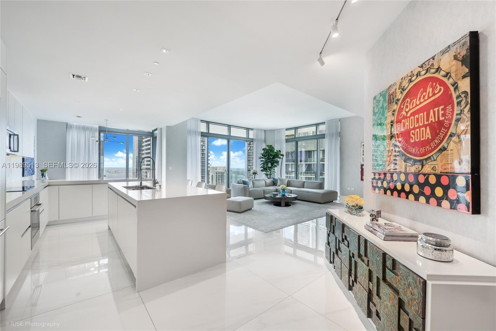 88 Southwest 7th Street, Unit 4101 Miami, FL 33130 - Photo 1 of 35 a large white kitchen with a large window and stainless steel appliances