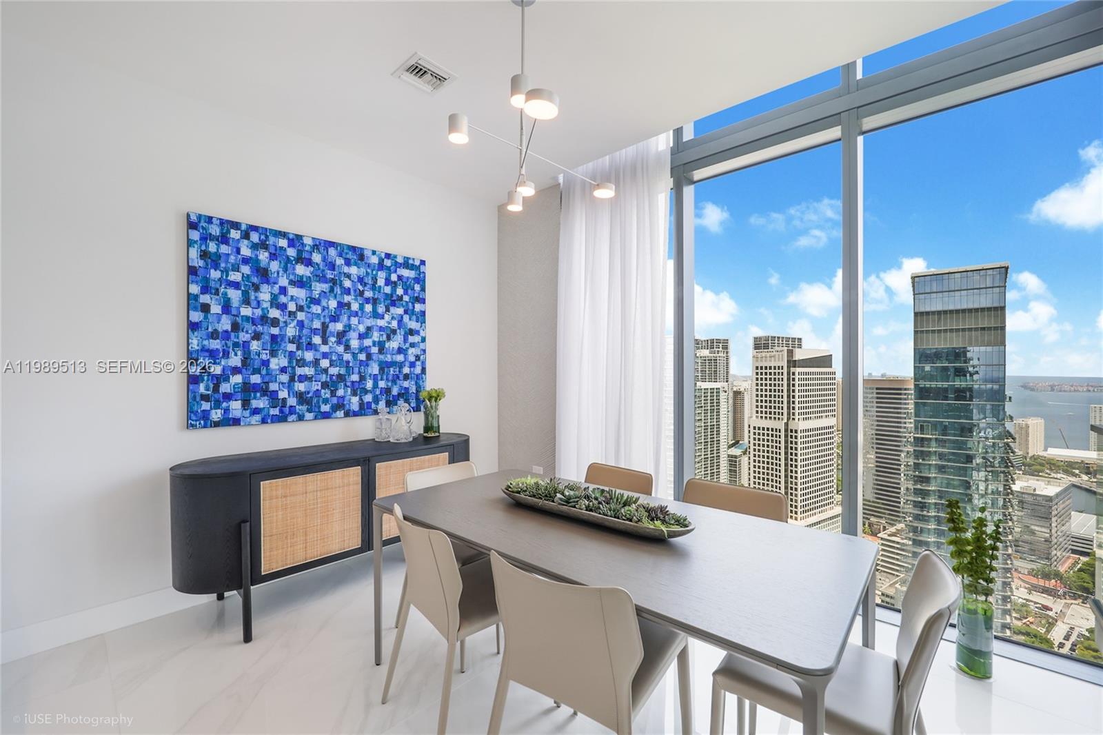 88 Southwest 7th Street, Unit 4101 Miami, FL 33130 - Photo 13 of 35 a view of a dining room with furniture window and wooden floor