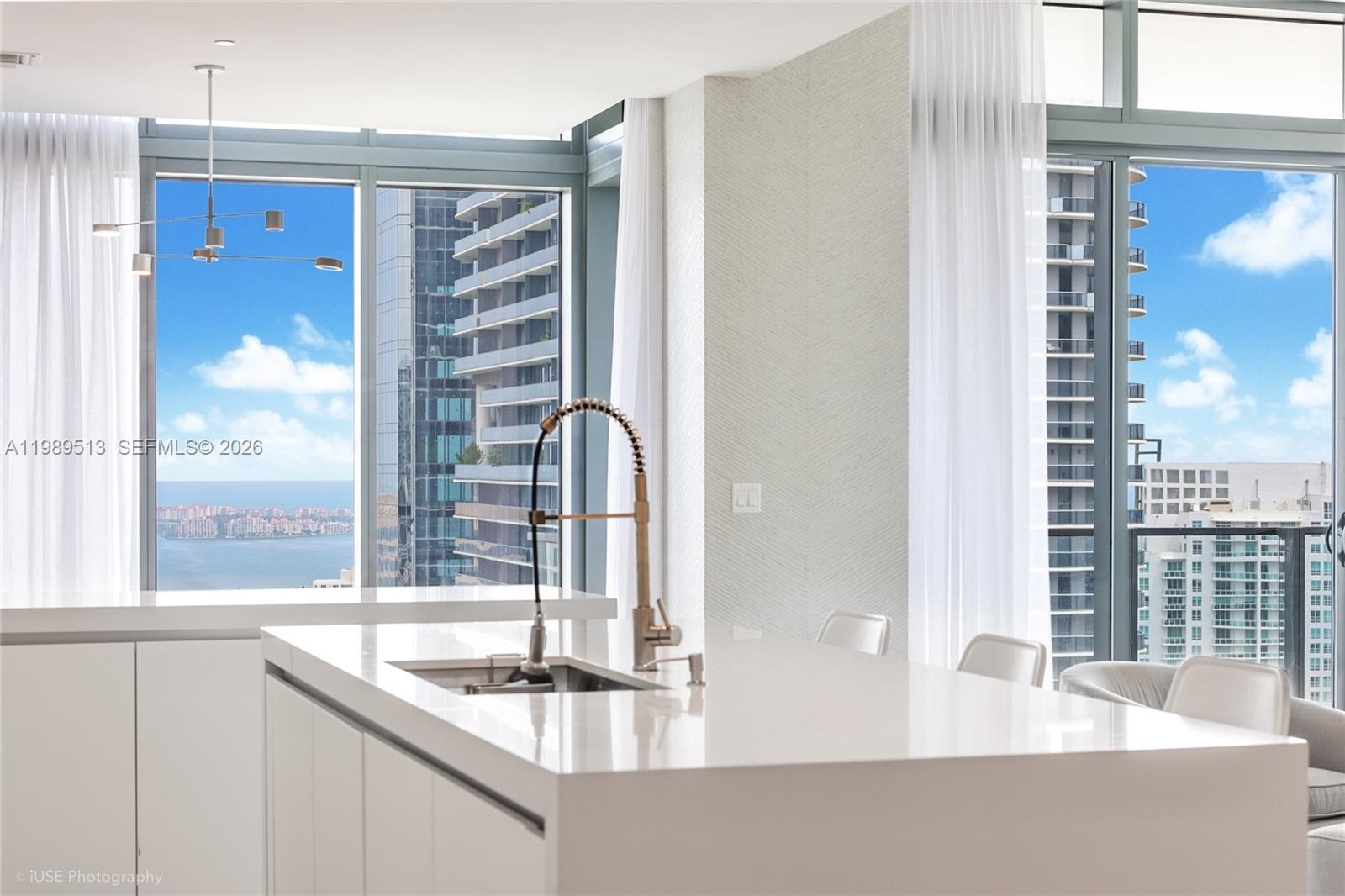 88 Southwest 7th Street, Unit 4101 Miami, FL 33130 - Photo 14 of 35 a bathroom with a granite countertop sink and a window