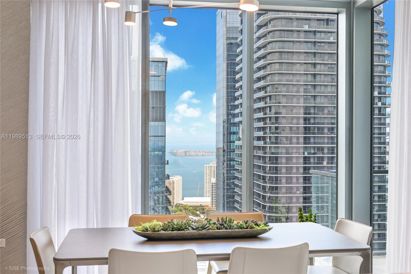 88 Southwest 7th Street, Unit 4101 Miami, FL 33130 - Photo 17 of 35 a view of a dining room with furniture and a window