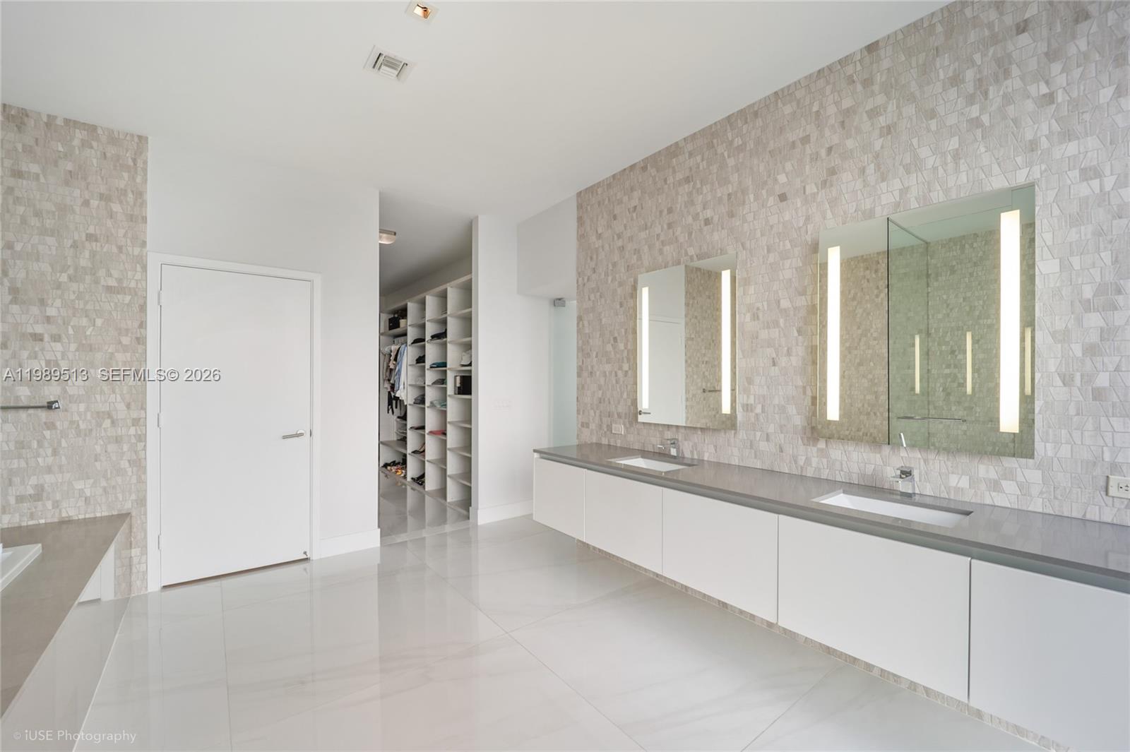 88 Southwest 7th Street, Unit 4101 Miami, FL 33130 - Photo 23 of 35 a large white kitchen with a sink and dishwasher a fireplace with wooden floor