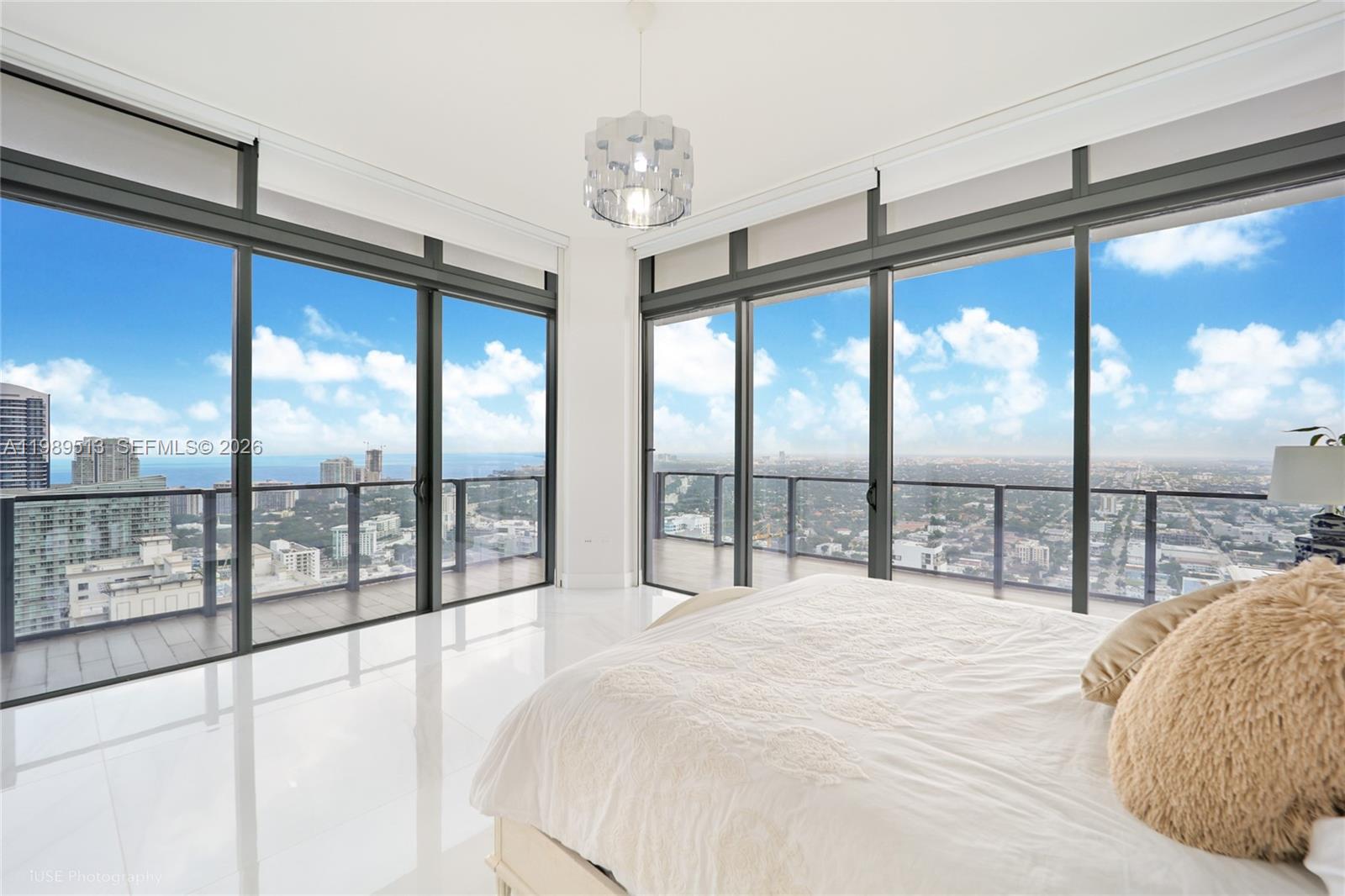88 Southwest 7th Street, Unit 4101 Miami, FL 33130 - Photo 26 of 35 a spacious bedroom with a large window and a balcony