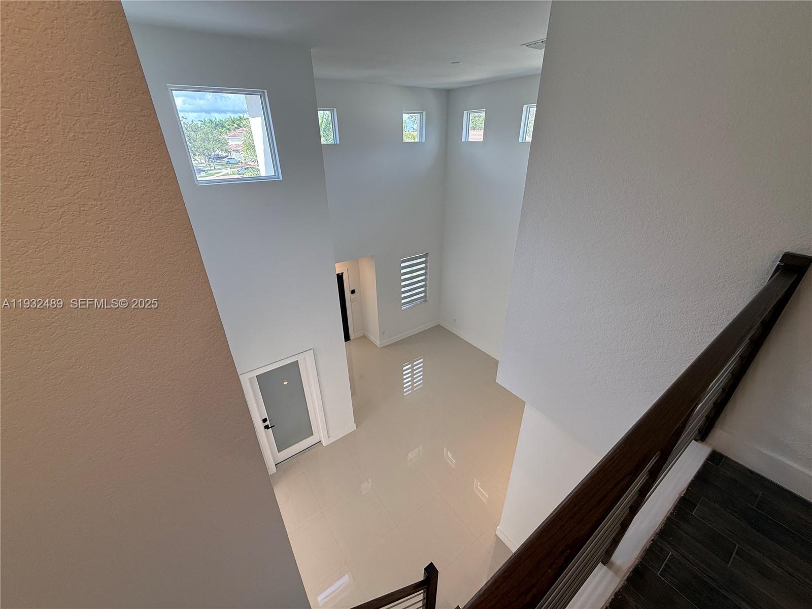 107 Southeast 22nd Terrace Homestead, FL 33033 - Photo 11 of 24 view of room with window and stairs