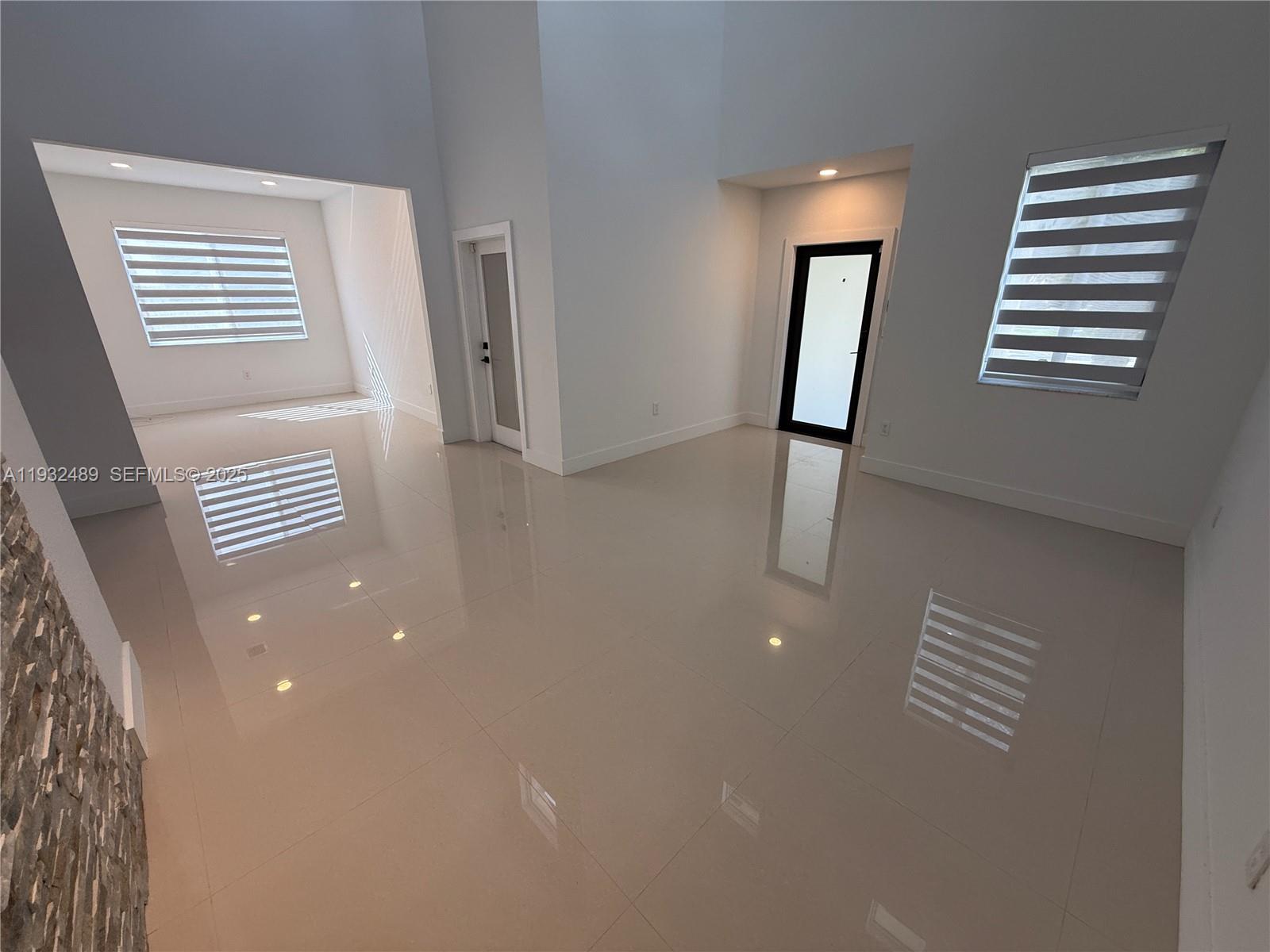 107 Southeast 22nd Terrace Homestead, FL 33033 - Photo 5 of 24 a view of kitchen and entryway with furniture