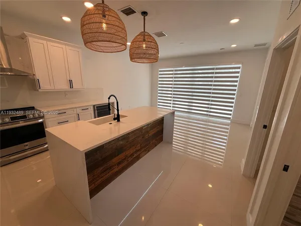 a kitchen with a sink and a refrigerator