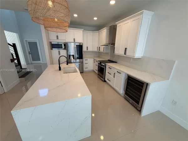 a kitchen with stainless steel appliances a stove sink microwave and cabinets