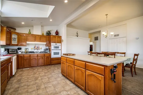 a kitchen with stainless steel appliances granite countertop a stove and cabinets