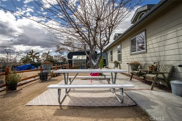 a view of a patio with a table and chairs