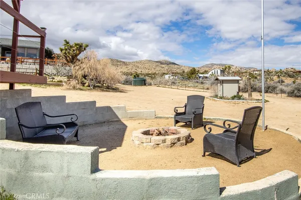 a kitchen with stainless steel appliances granite countertop a refrigerator a stove a sink and a microwave