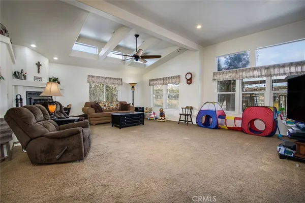 a living room with furniture a window and a ceiling fan