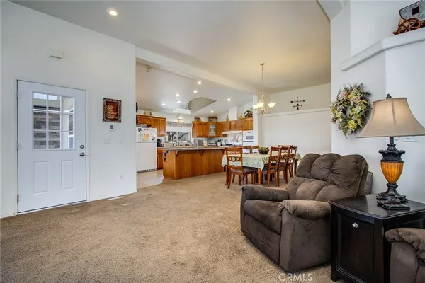 a living room with furniture and a kitchen view