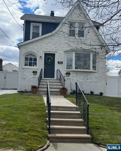 a front view of house with a garden