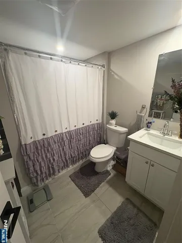 a bathroom with a toilet sink and shower