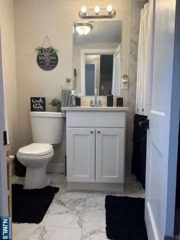 a bathroom with a sink a toilet and mirror